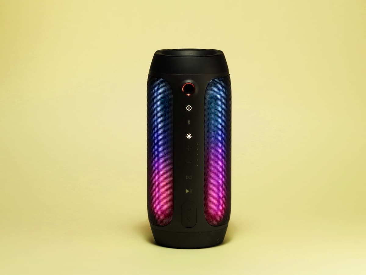 Compact black speaker on a clean surface